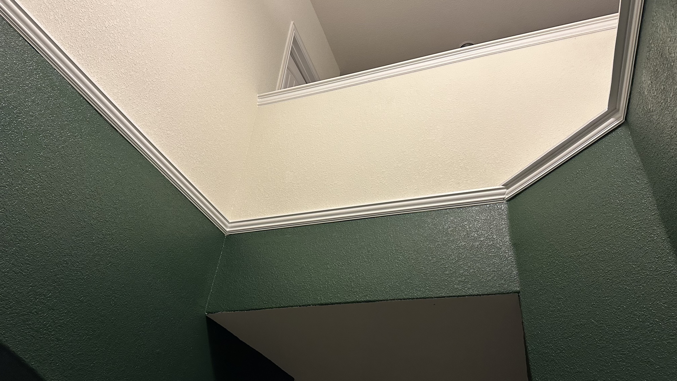 Clean, coped molding spanning complex angles in a ceiling feature